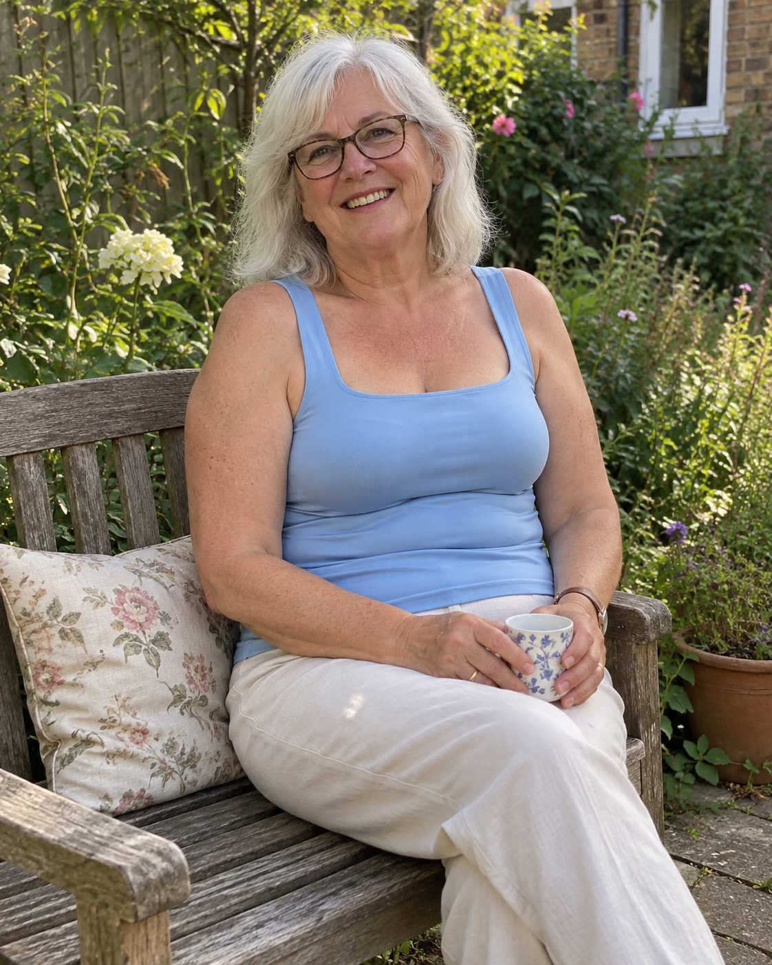 Woman relaxing on a garden bench in the comfort shaper tank in Sky Blue