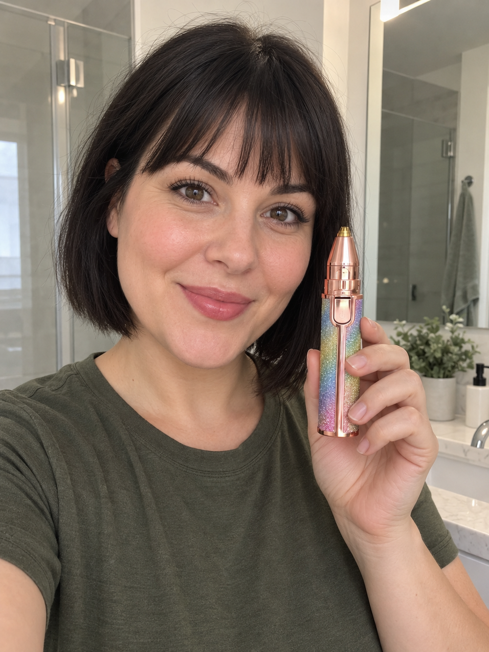 Woman holding eyebrow trimmer