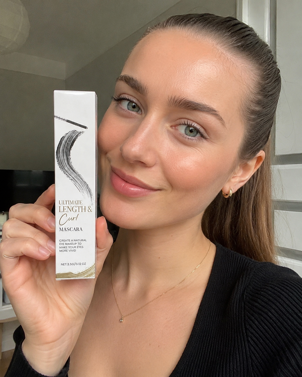 Customer holding the Beauty Kiwi Waterproof Curl and Length Mascara, natural makeup look