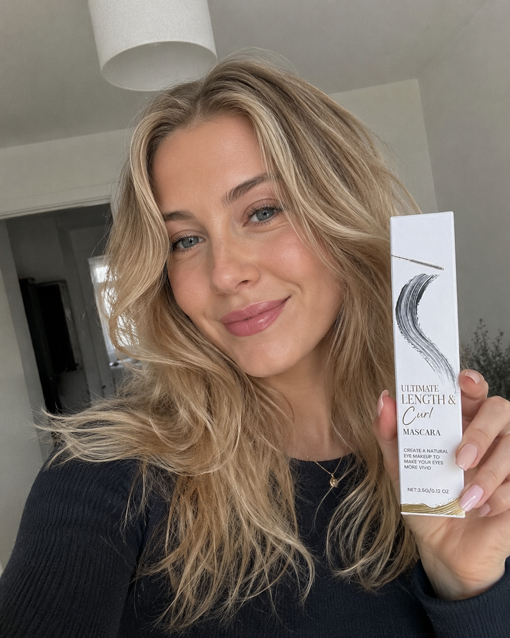 Customer holding the Beauty Kiwi Waterproof Curl and Length Mascara, indoor natural light